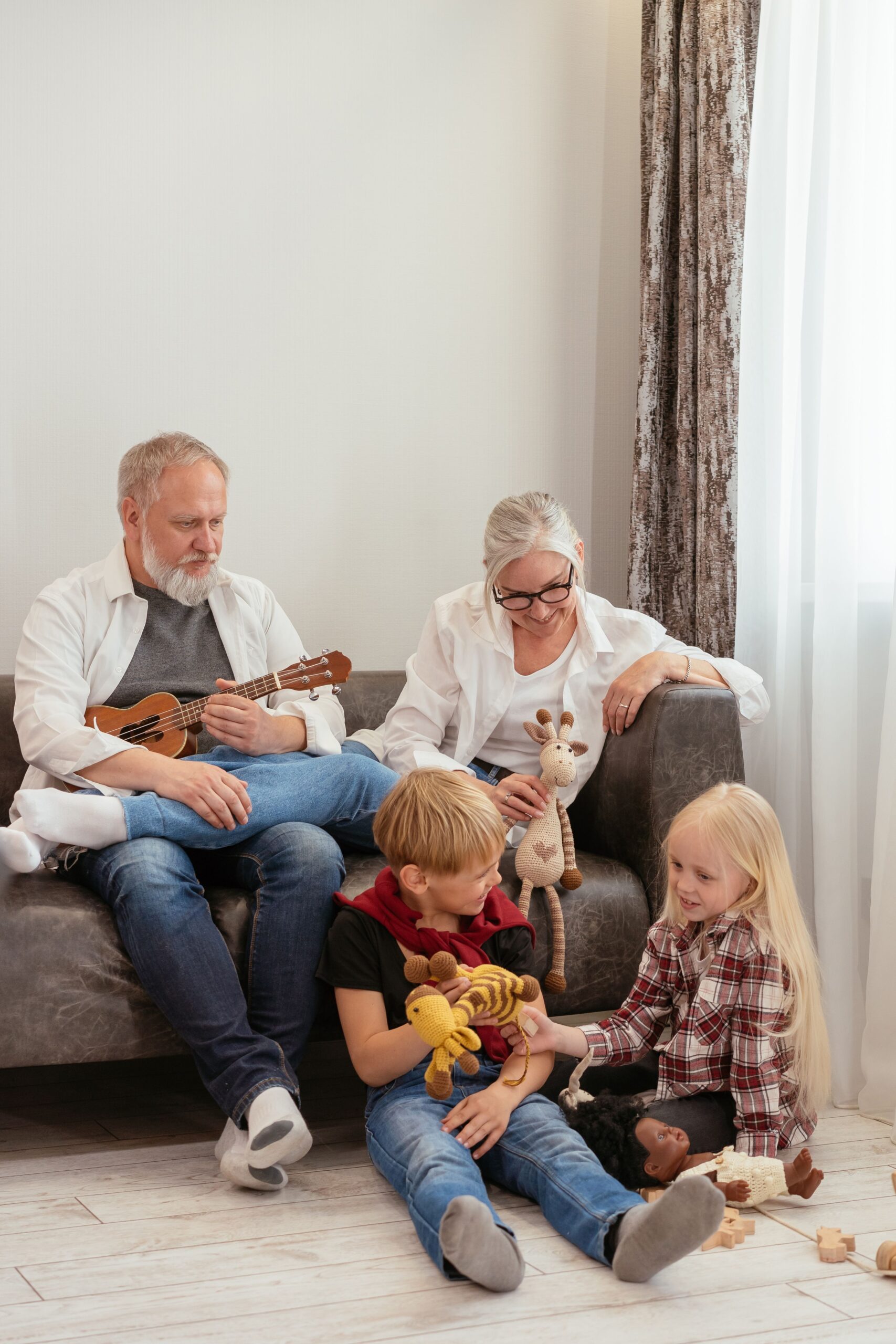 Grandparents and kids enjoying quality time indoors with ukulele and toys.